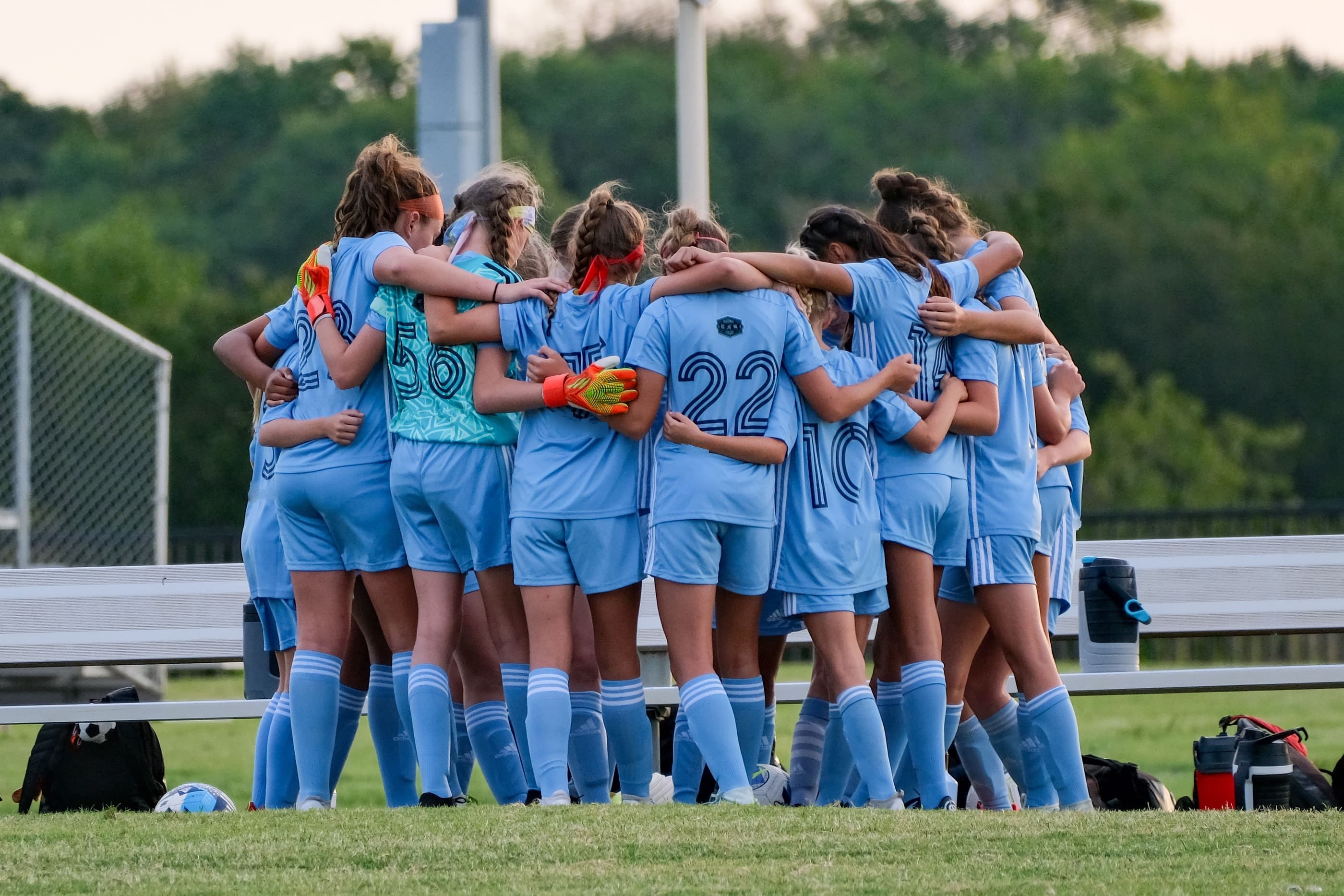 A youth soccer team huddled together before a game